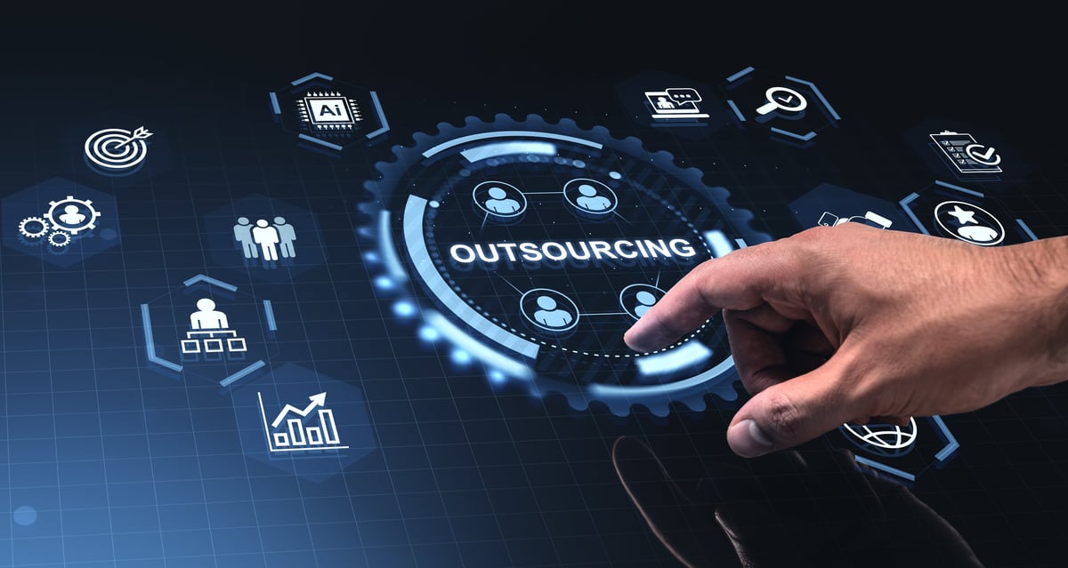 Hand interacting with illuminated outsourcing icons in futuristic graphic style on dark background, concept of modern business operations